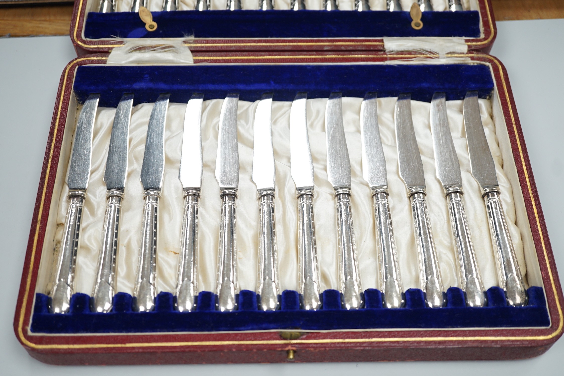 A cased set of twelve pairs of Victorian mother of pearl handed silver fish eaters (fork missing) R.F. Mosley & Co, Sheffield, 1894/1895 and a later cased set of twelve pairs of silver handled dessert eaters.